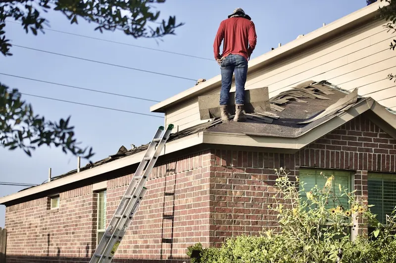 Professional roofer working on a residential roof in Westtown